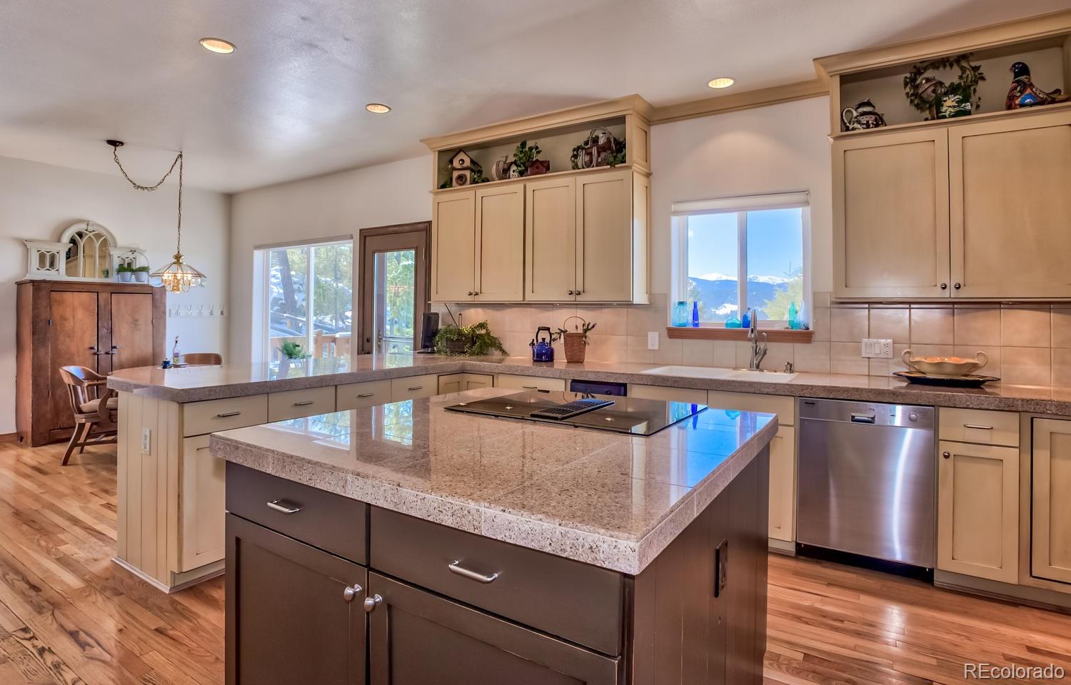 29323 Gray Hawk Drive Evergreen, CO 80439 - Photo 4 of 31 a kitchen with granite countertop a sink a counter top space and cabinets