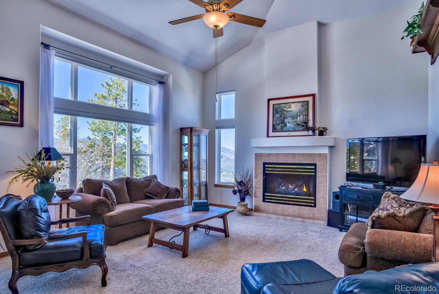 29323 Gray Hawk Drive Evergreen, CO 80439 - Photo 8 of 31 a living room with furniture and a fireplace