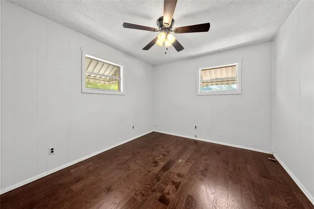 a view of a house with backyard and a backyard