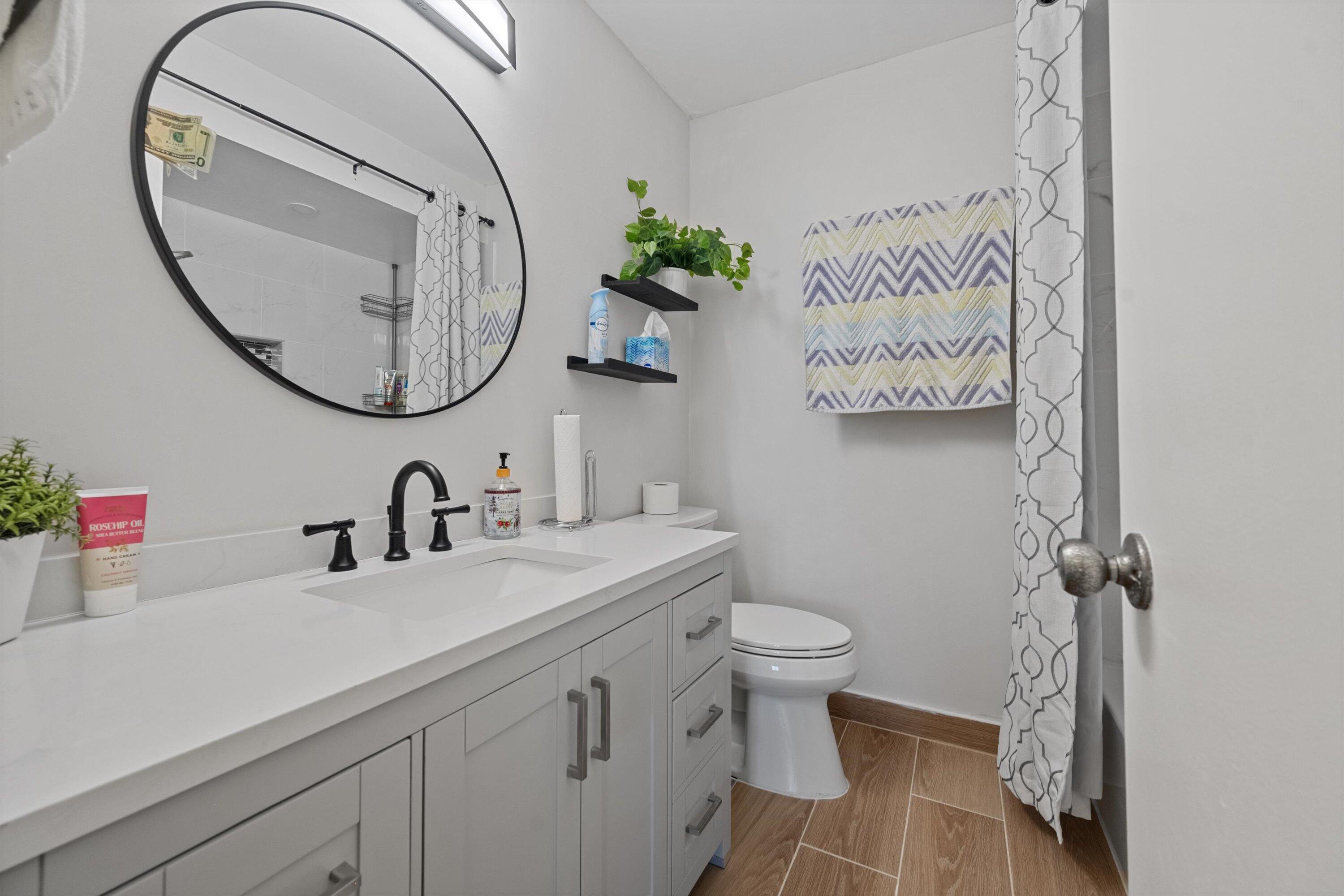 9273 Southwest 8th Street, Unit 416 Boca Raton, FL 33428 - Photo 13 of 19 a bathroom with a sink and a mirror