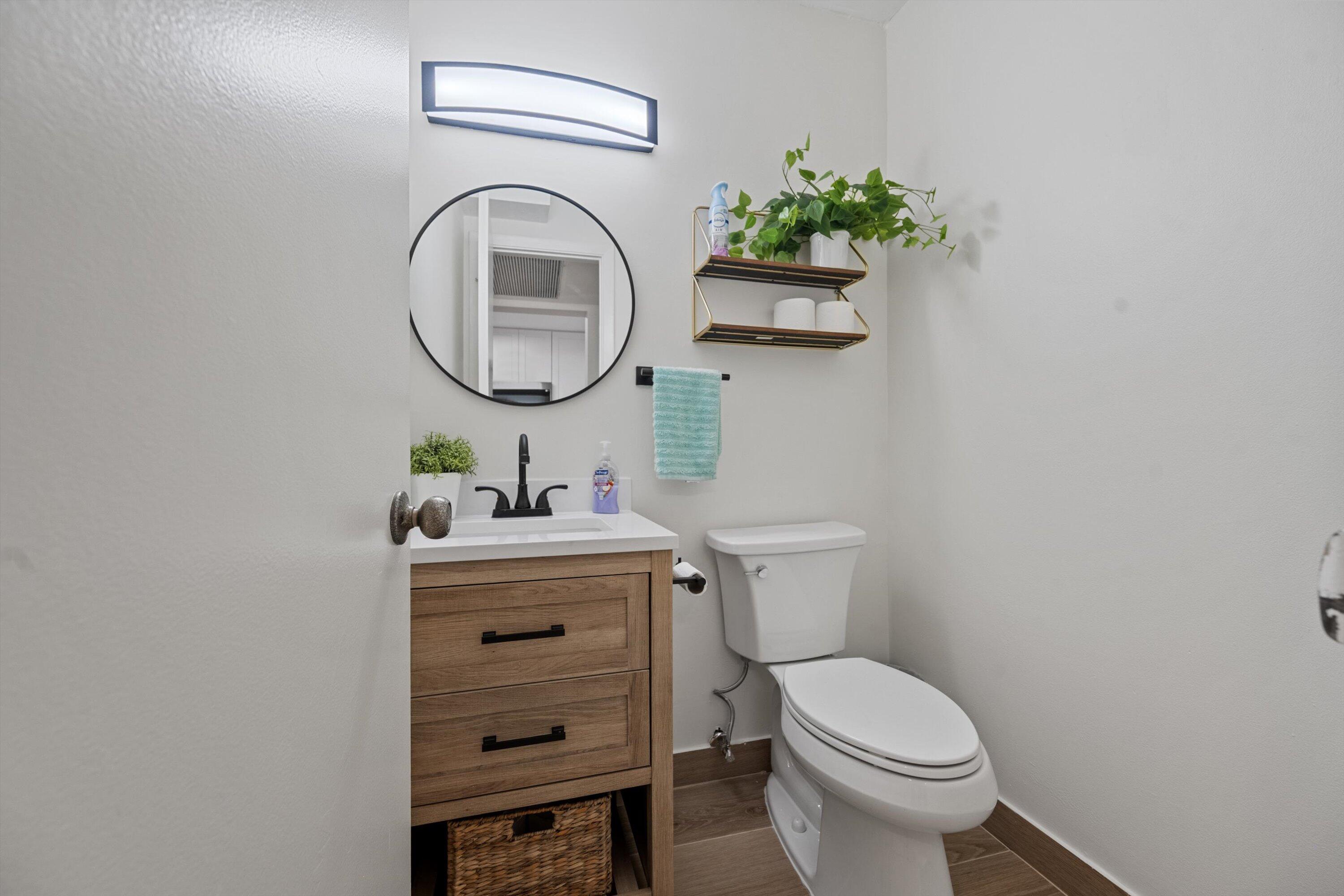 9273 Southwest 8th Street, Unit 416 Boca Raton, FL 33428 - Photo 16 of 19 a bathroom with a sink mirror and toilet