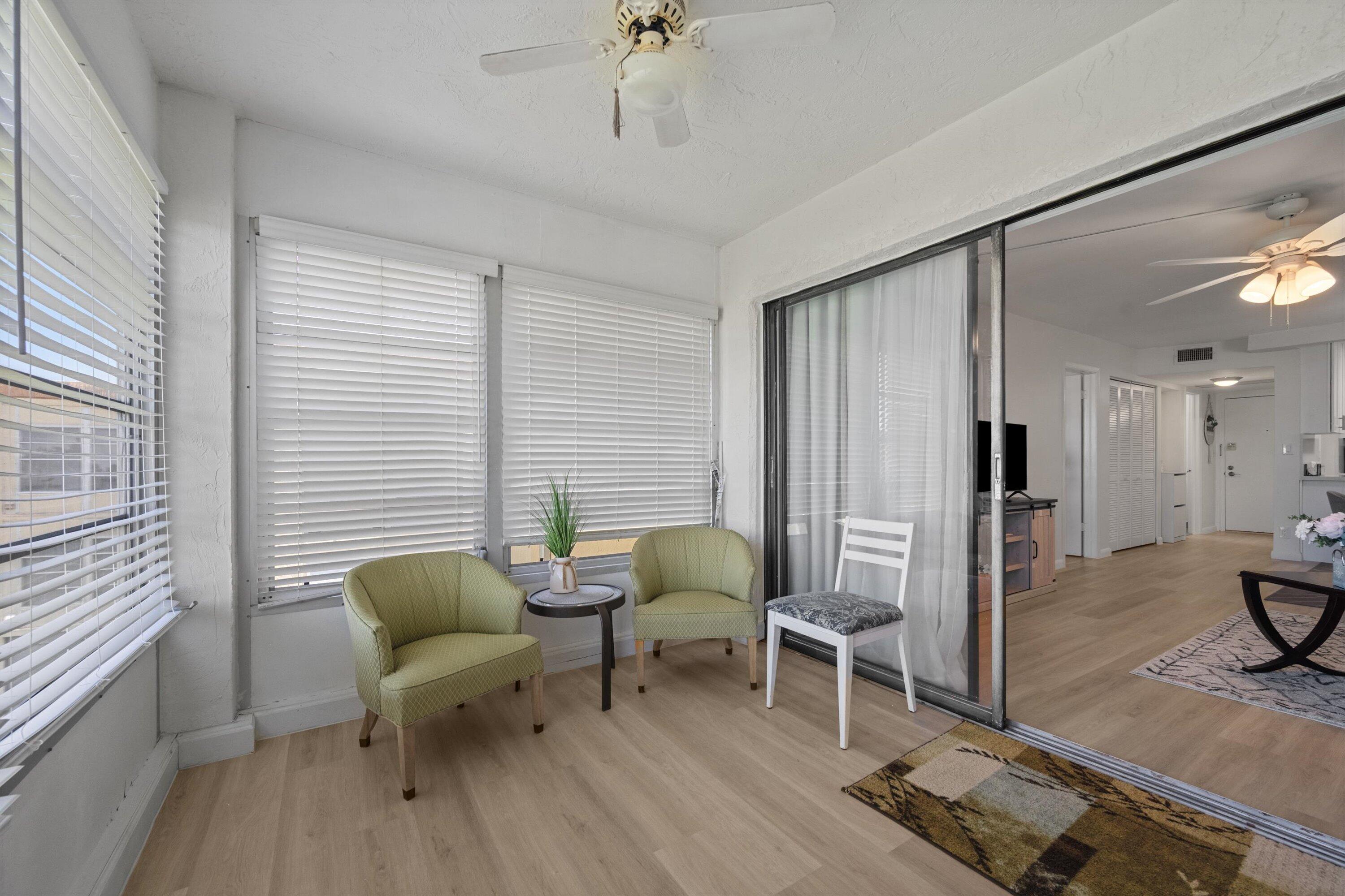 9273 Southwest 8th Street, Unit 416 Boca Raton, FL 33428 - Photo 19 of 19 a living room with furniture and a wooden floor