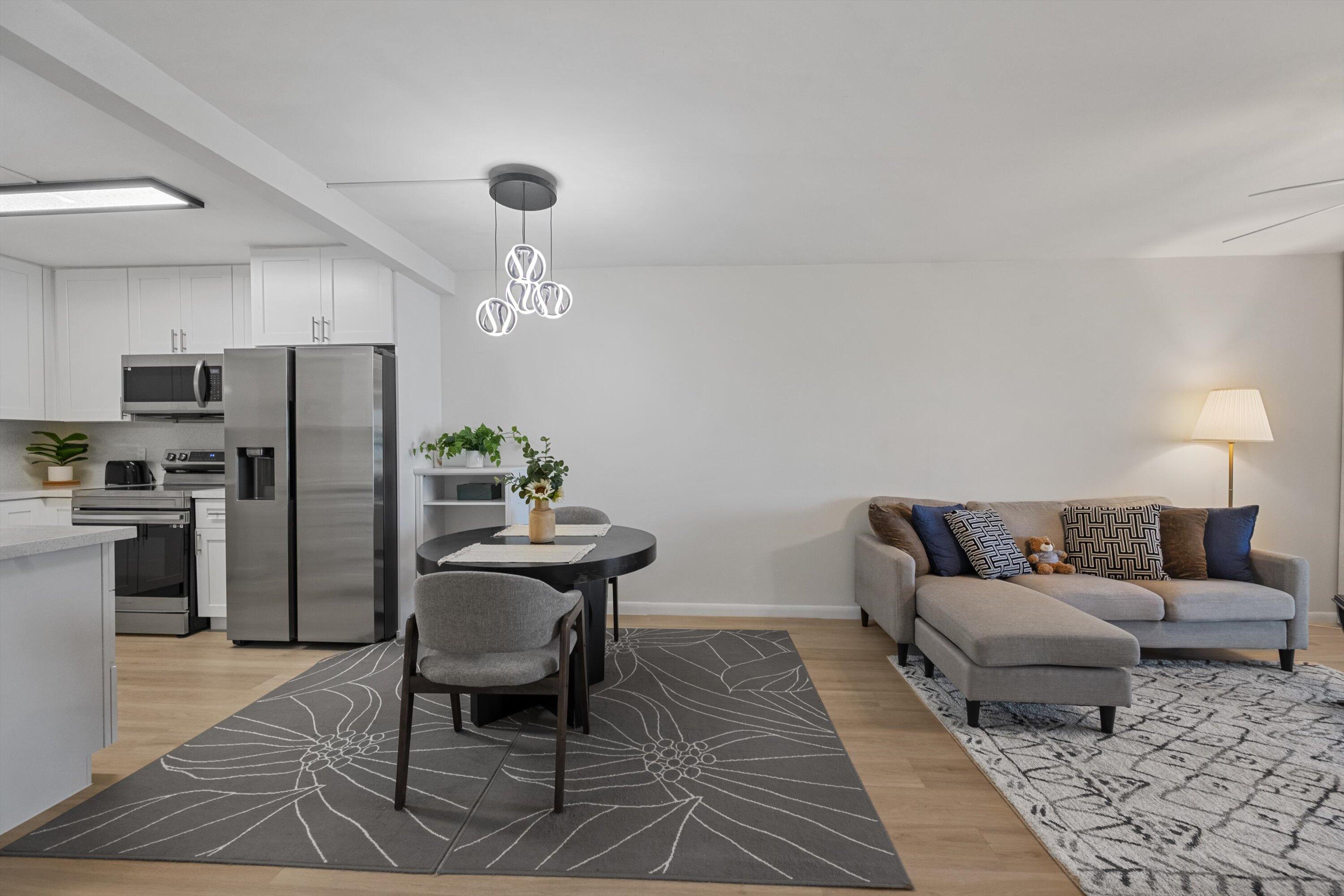 9273 Southwest 8th Street, Unit 416 Boca Raton, FL 33428 - Photo 7 of 19 a living room with furniture and a table