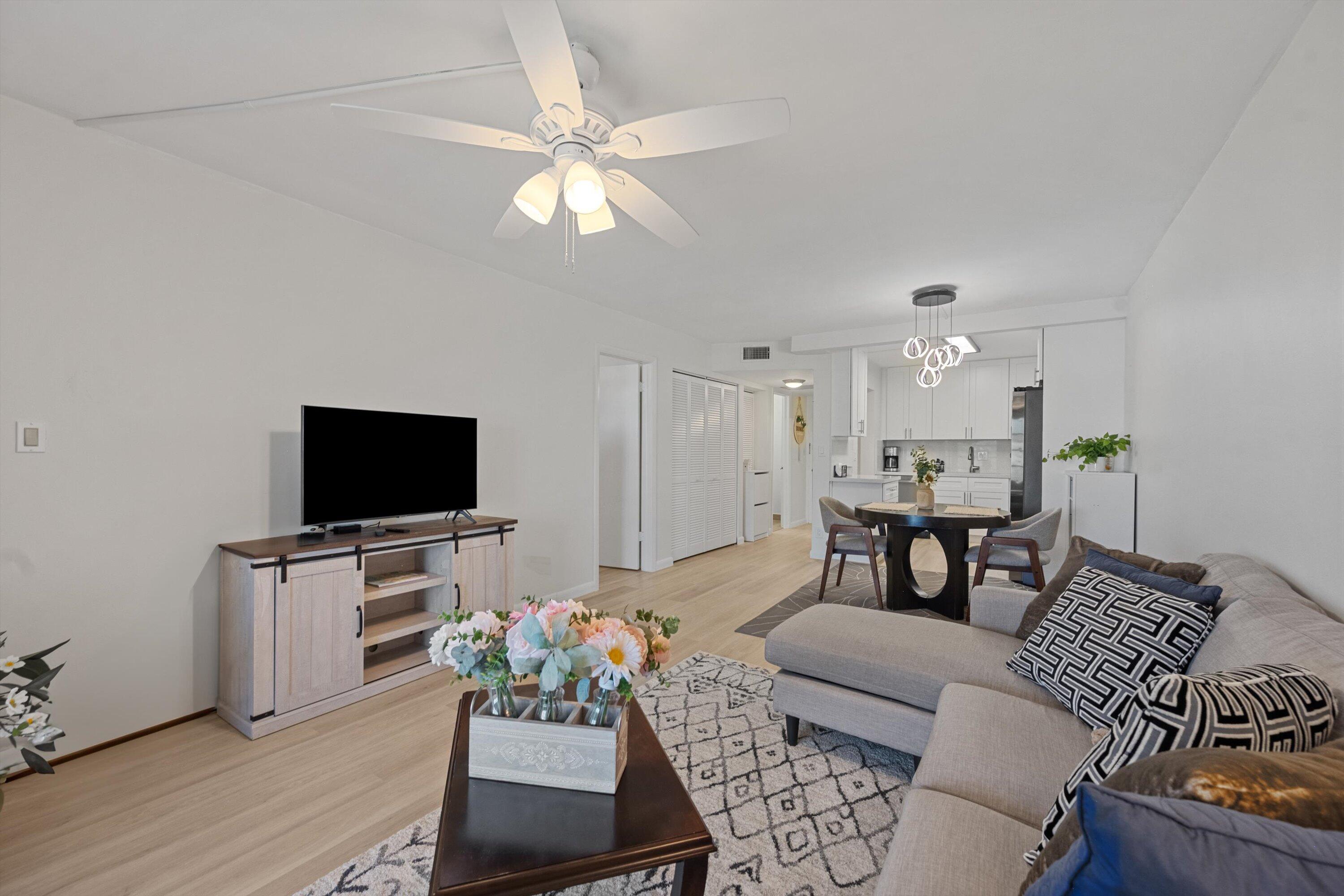 9273 Southwest 8th Street, Unit 416 Boca Raton, FL 33428 - Photo 8 of 19 a living room with furniture and a flat screen tv