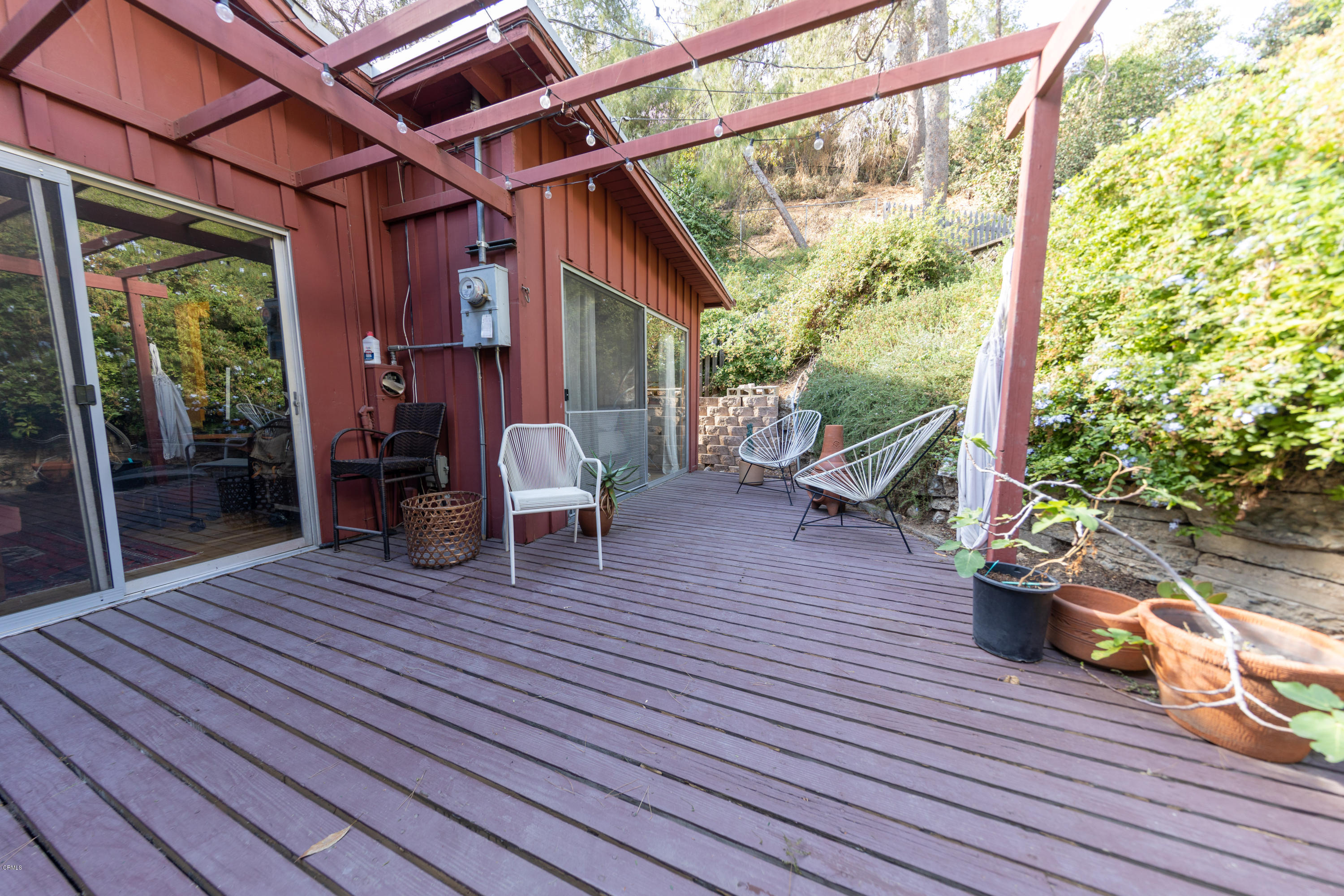 503 Quail Drive Los Angeles, CA 90065 - Photo 14 of 16 a view of a patio with table and chairs potted plants with wooden floor and floor to ceiling window