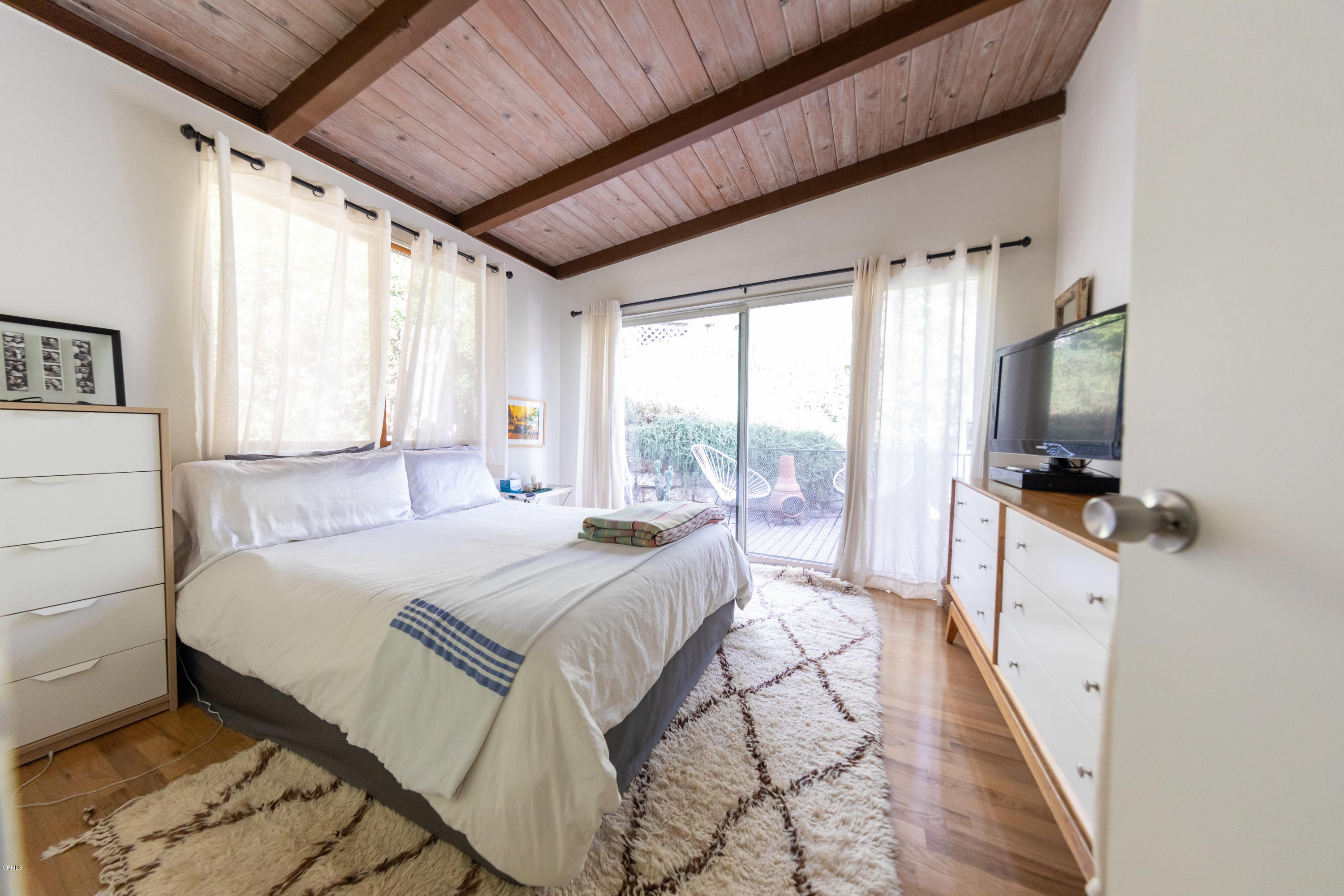 503 Quail Drive Los Angeles, CA 90065 - Photo 9 of 16 a bedroom with a bed and large windows