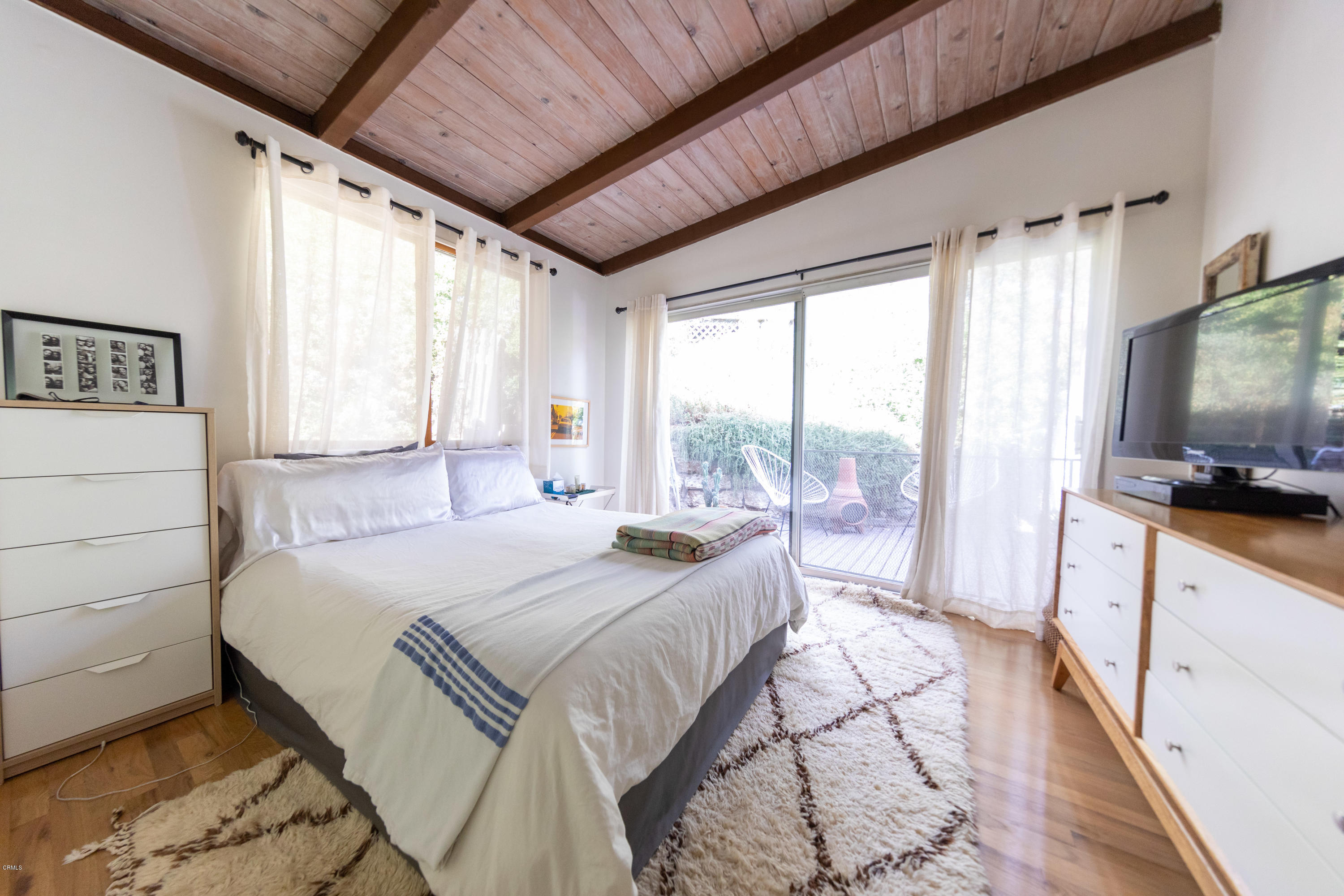 503 Quail Drive Los Angeles, CA 90065 - Photo 10 of 16 a bedroom with a large bed and a flat tv screen on dresser