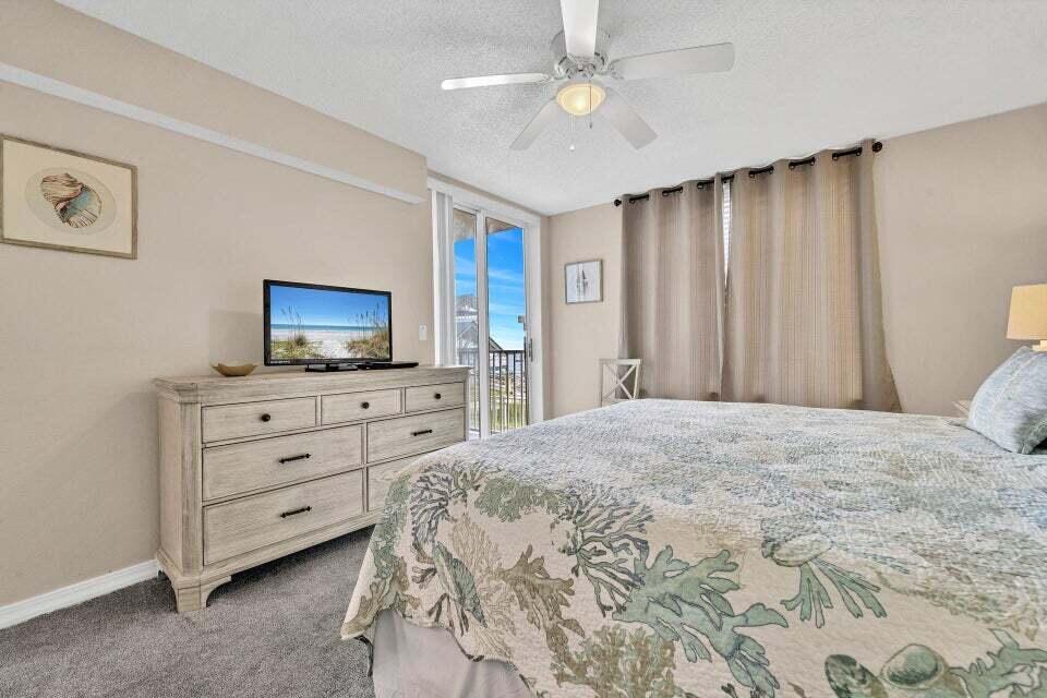 520 Santa Rosa Boulevard, Unit 217 Fort Walton Beach, FL 32548 - Photo 11 of 26 a bedroom with a bed and a flat screen tv