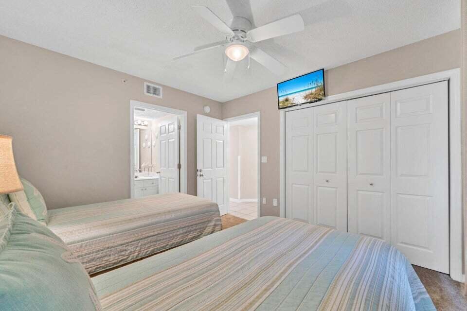 520 Santa Rosa Boulevard, Unit 217 Fort Walton Beach, FL 32548 - Photo 14 of 26 a bedroom with a large bed a chandelier and a window