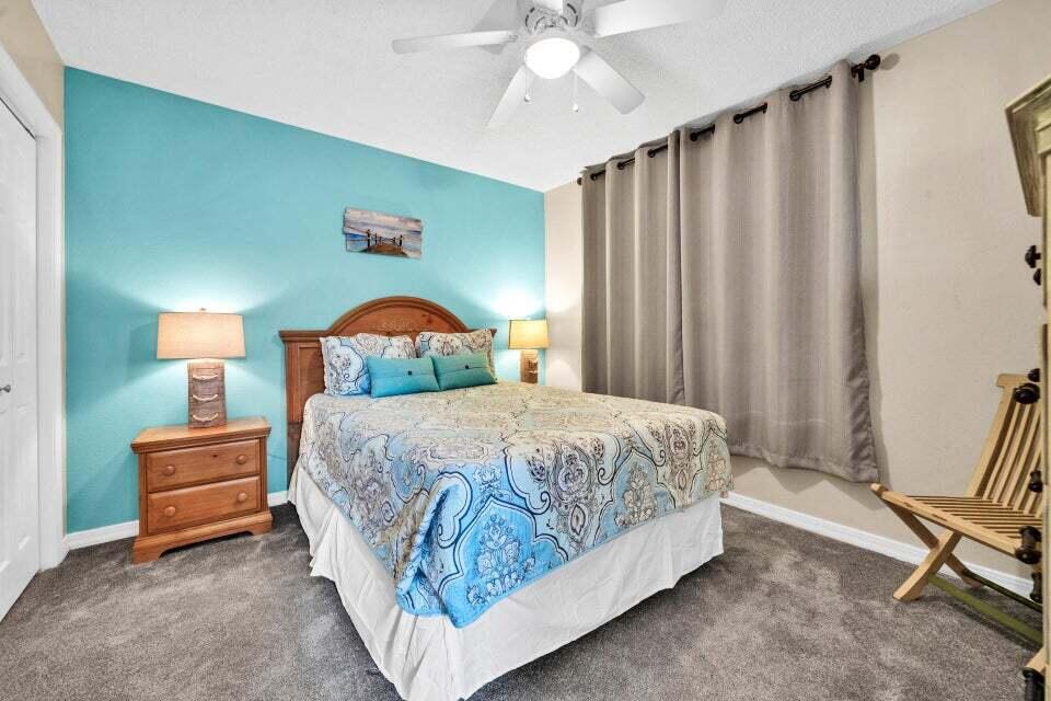 520 Santa Rosa Boulevard, Unit 217 Fort Walton Beach, FL 32548 - Photo 15 of 26 a bedroom with a bed lamp and a desk