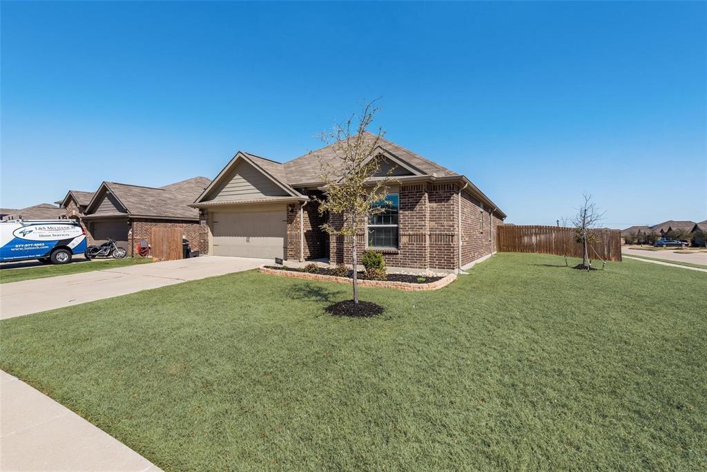 1837 Rialto Lane Crowley, TX 76036 - Photo 20 of 24 Brick exterior with a gabled roofline, an attached garage, a concrete driveway, and a front yard with a landscaping bed