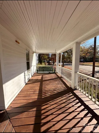 a view of a balcony with wooden floor
