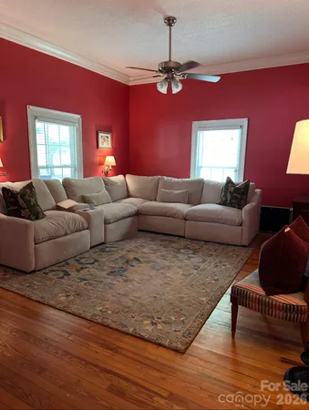 a view of empty room with wooden floor and fireplace