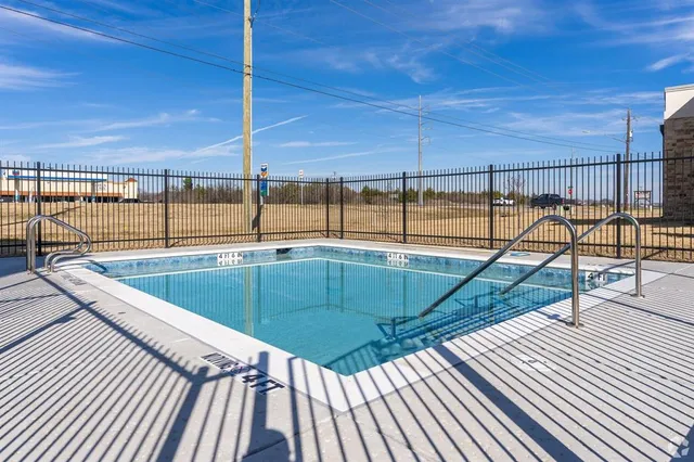 a view of swimming pool with a chairs