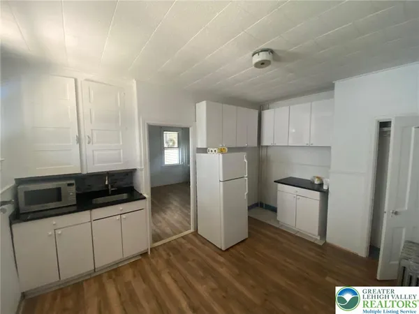 a kitchen with a refrigerator sink and stove