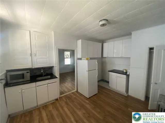 a kitchen with a refrigerator sink and stove