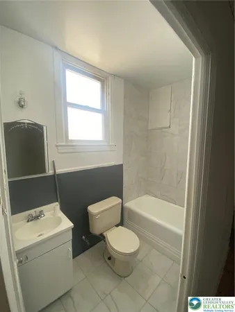 a bathroom with a toilet a sink and bathtub
