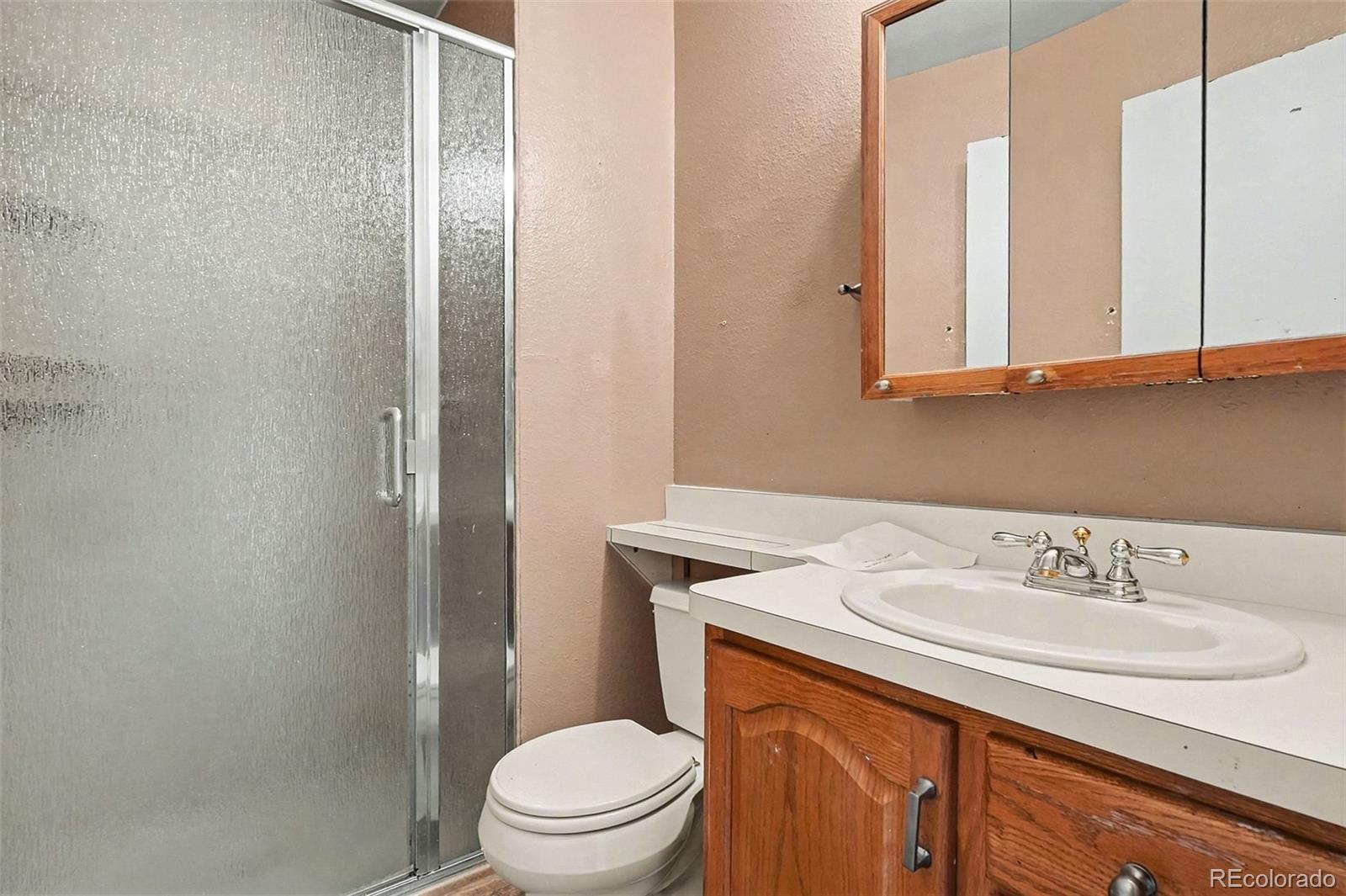 4105 South Laredo Way Aurora, CO 80013 - Photo 6 of 11 a bathroom with a sink toilet and mirror