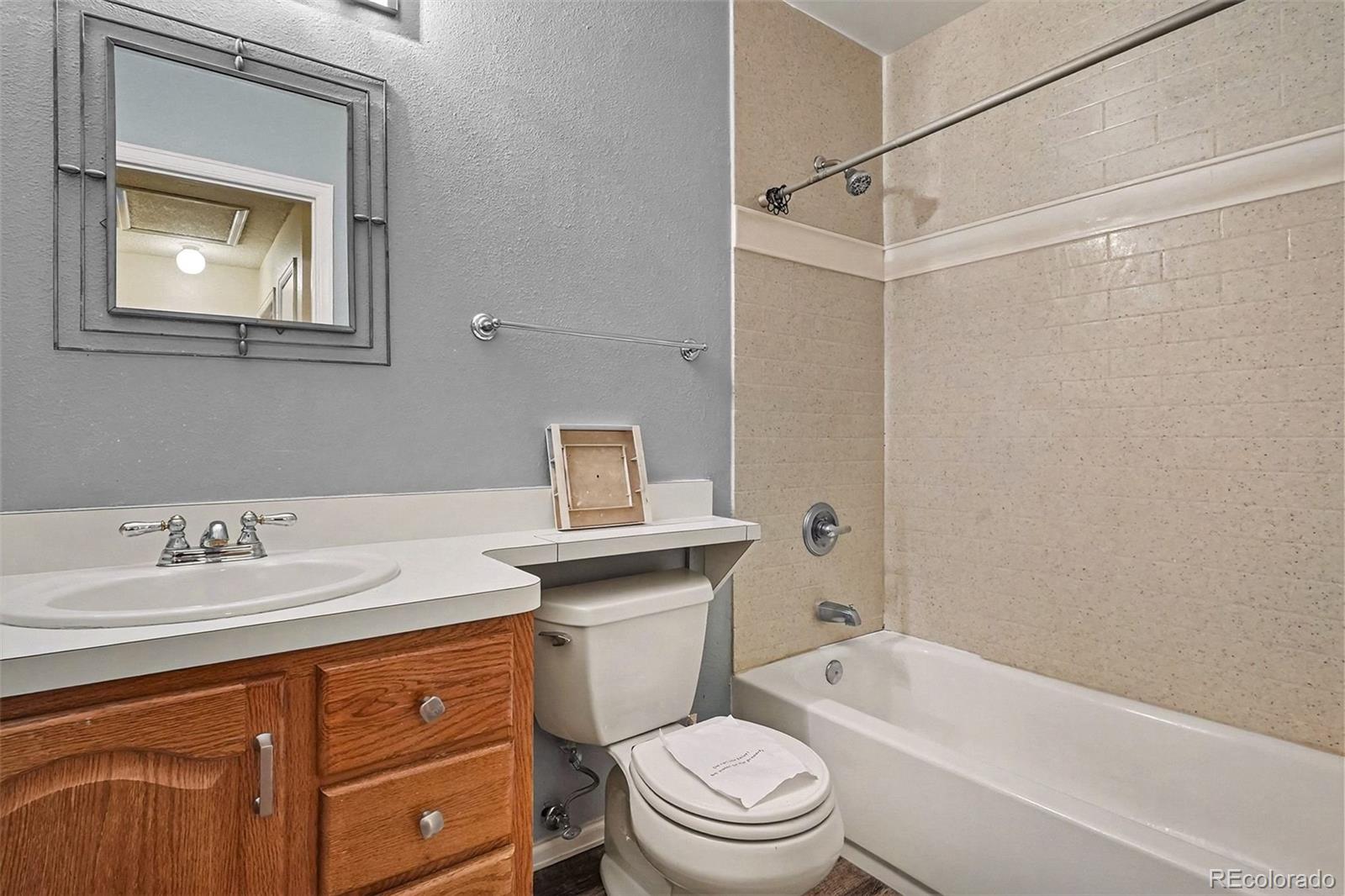 4105 South Laredo Way Aurora, CO 80013 - Photo 9 of 11 a bathroom with a sink a toilet and shower