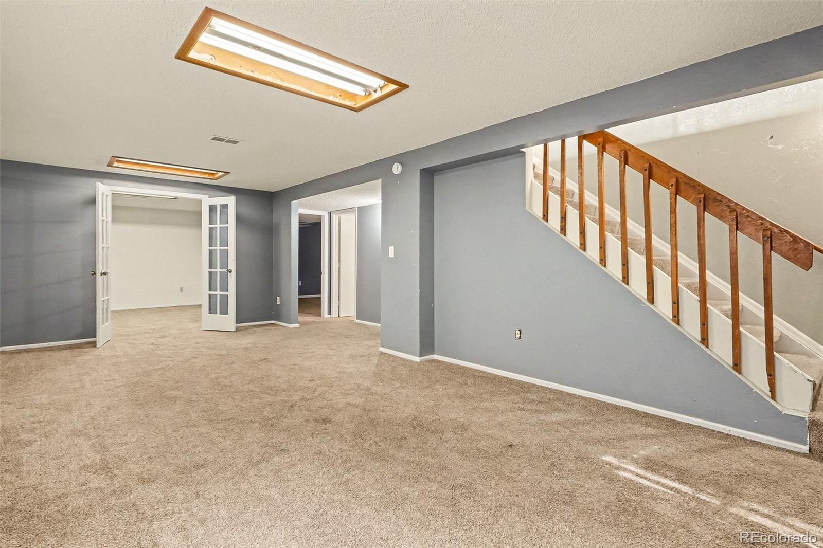 4105 South Laredo Way Aurora, CO 80013 - Photo 10 of 11 a view of an empty room with stairs