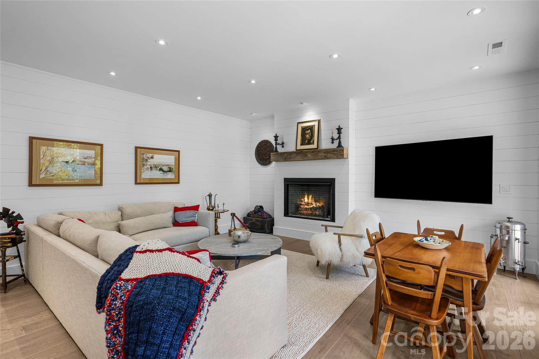 2235 Cold Mountain Road Lake Toxaway, NC 28747 - Photo 21 of 47 a living room with furniture flat screen tv and a fireplace