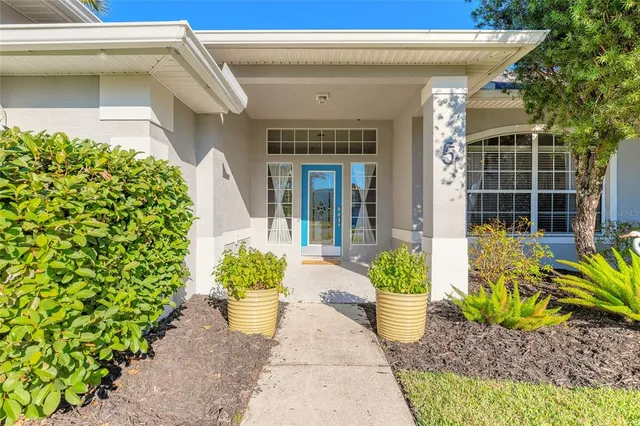 a front view of a house with a potted plant