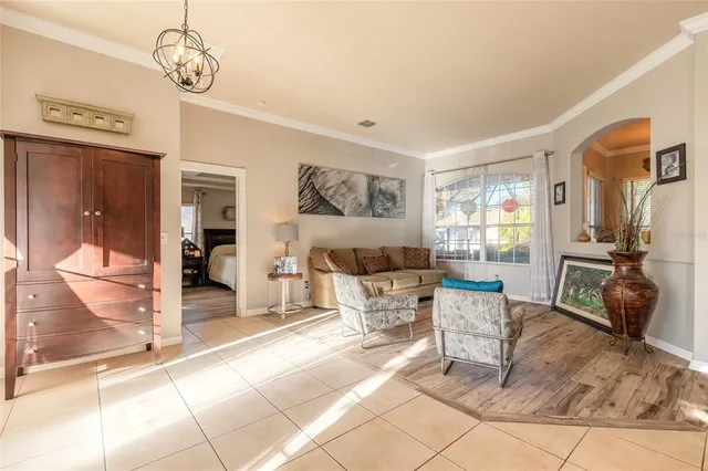 a living room with furniture and a chandelier