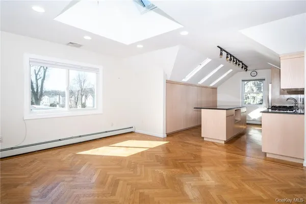 a view of room with window and wooden floor