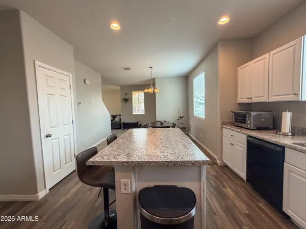 a kitchen with kitchen island a counter top space a sink stainless steel appliances and cabinets