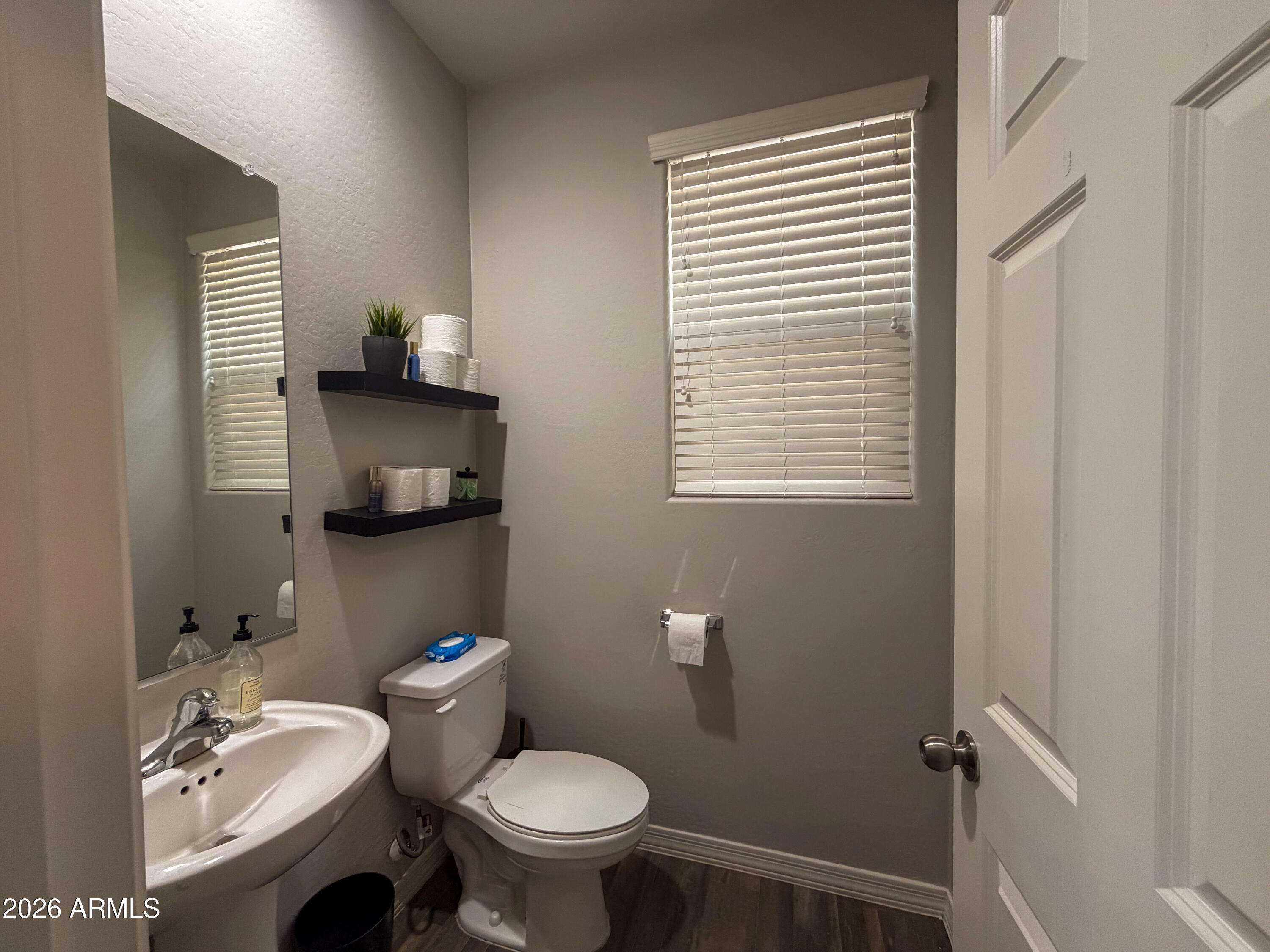 5480 Fulton Street Phoenix, AZ 85043 - Photo 24 of 63 a bathroom with a toilet sink and mirror