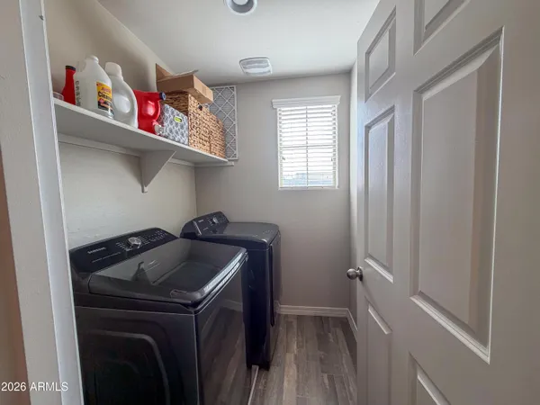 a spacious bedroom with a bed and a television