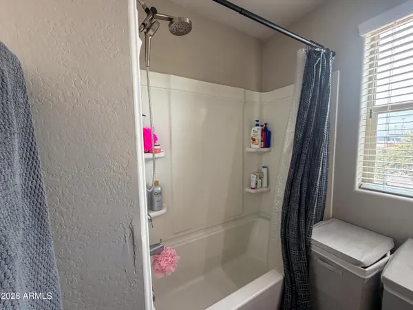 a bathroom with double vanity and a mirror