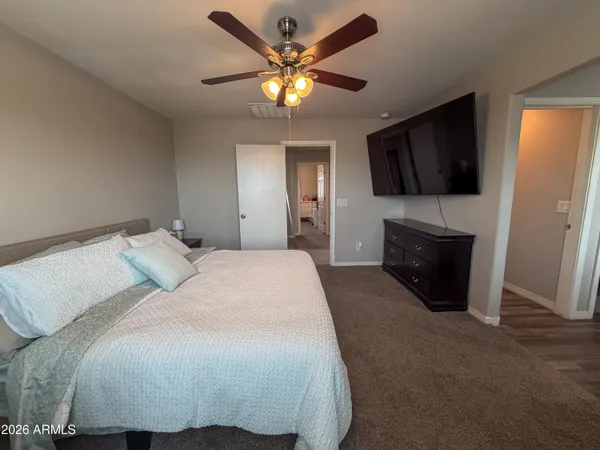 a bedroom with a bed and a chandelier