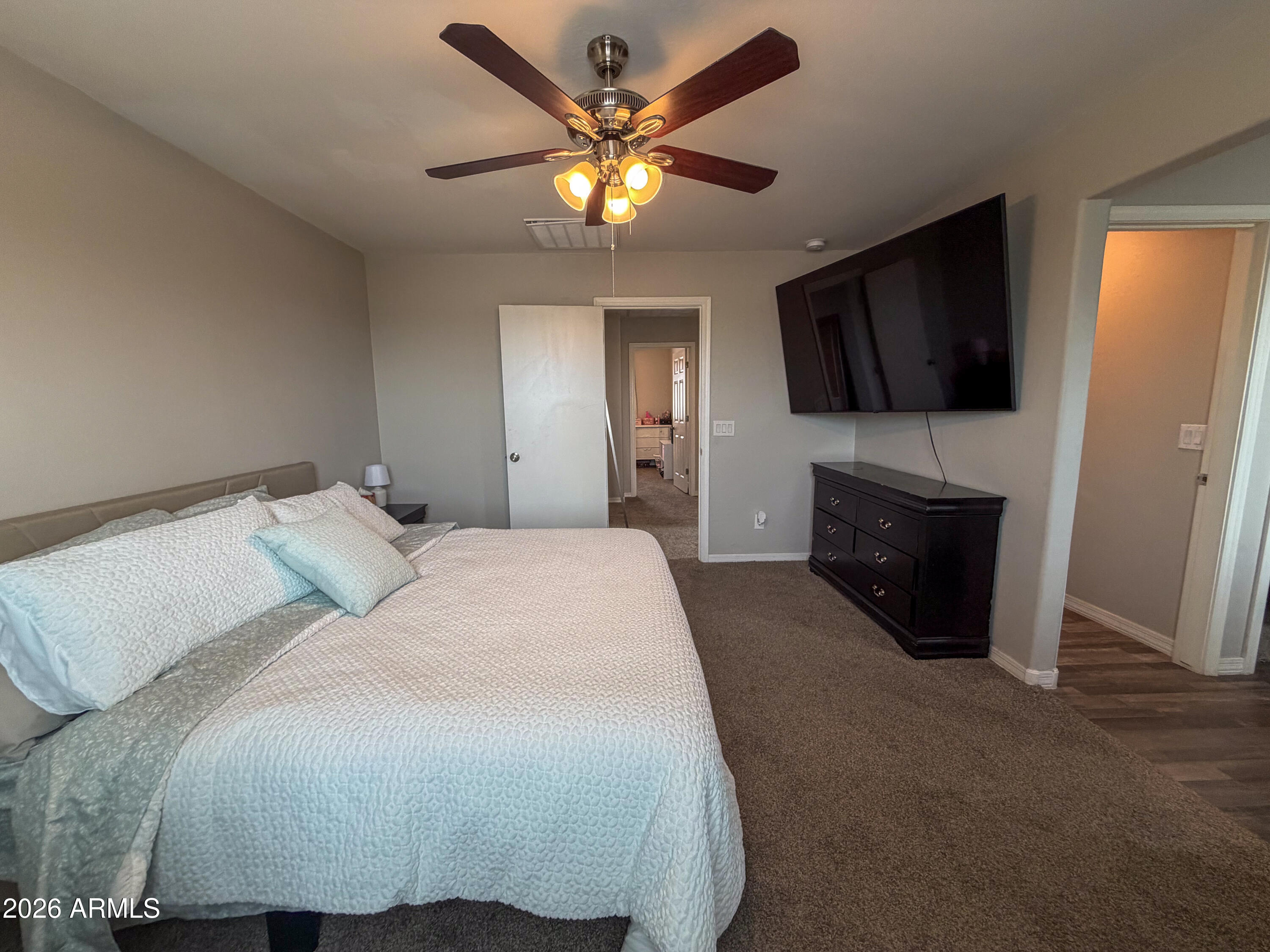 5480 Fulton Street Phoenix, AZ 85043 - Photo 34 of 63 a spacious bedroom with a bed and a flat screen tv