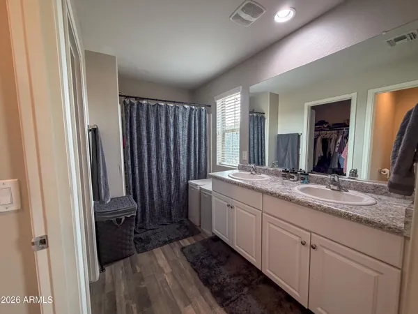 a view of walk in closet with clothes