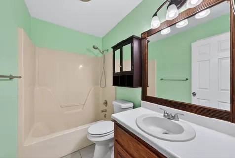 a living room with furniture and a lamp on table