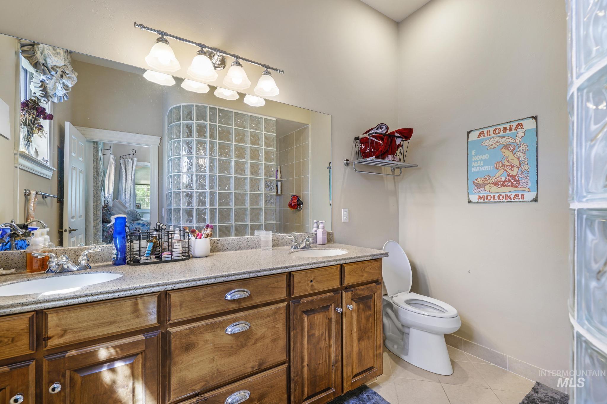 1526 Highway 26 Gooding, ID 83330 - Photo 23 of 48 Ensuite bathroom with light tile patterned floors and double vanity