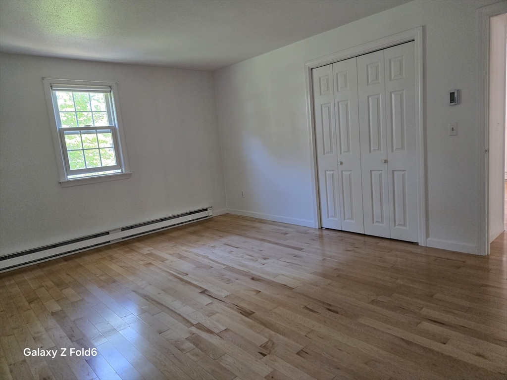 222 Buck Island Road, Unit 45 Yarmouth, MA 02673 - Photo 16 of 23 wooden floor in an empty room with a window