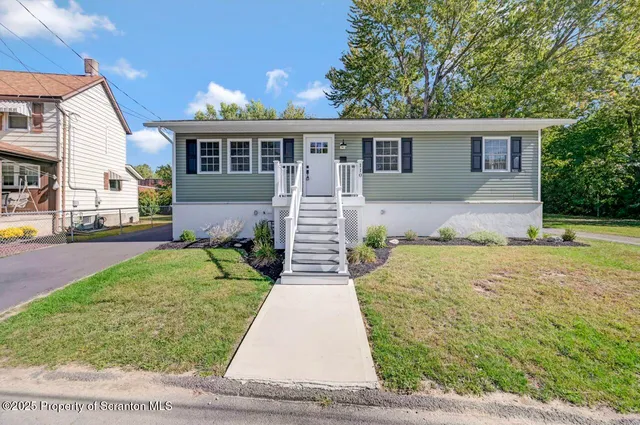 a front view of a house with a yard and porch