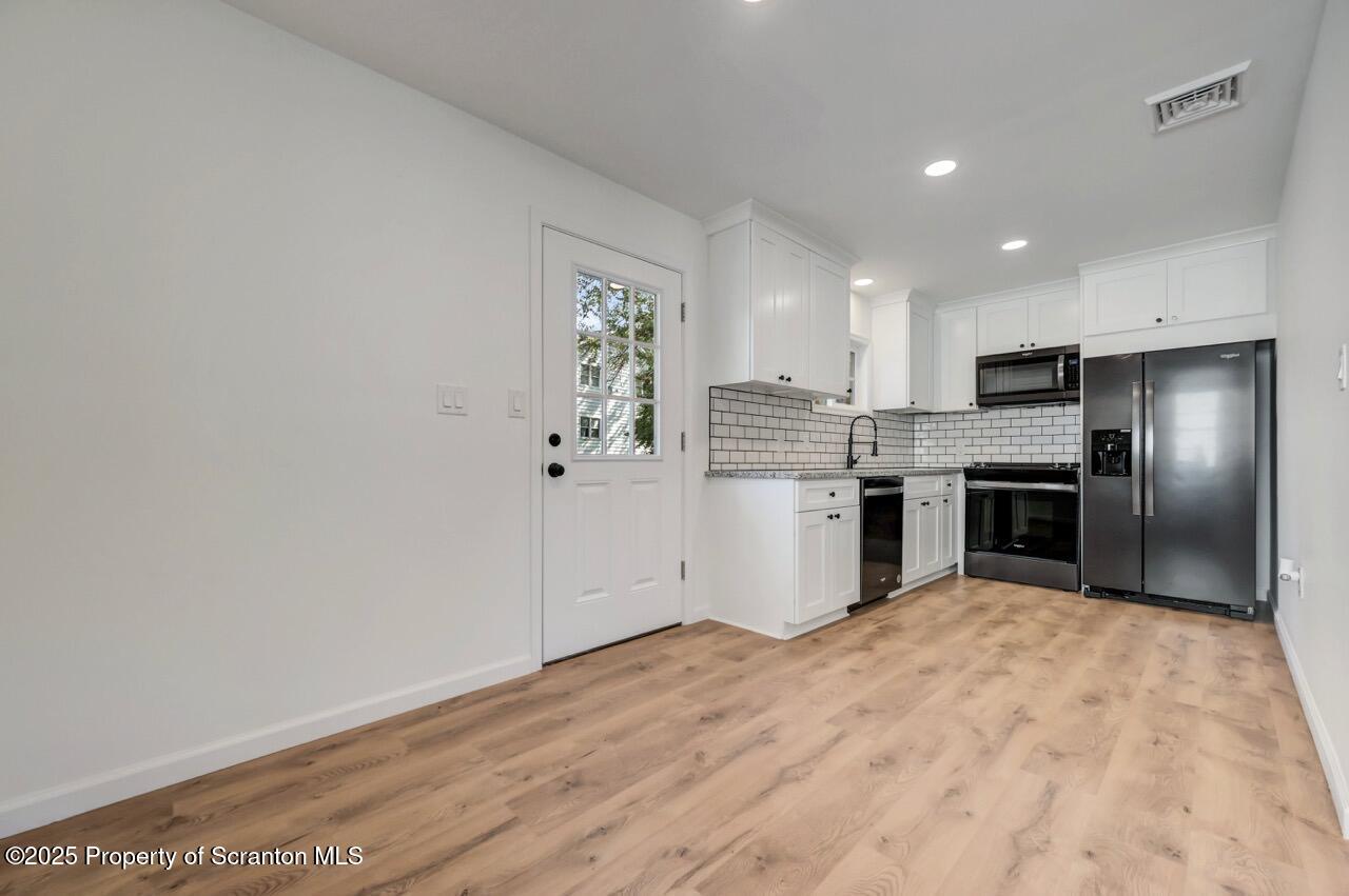 110 Morgan Street Jessup, PA 18434 - Photo 11 of 45 a kitchen with stainless steel appliances granite countertop a refrigerator and a stove