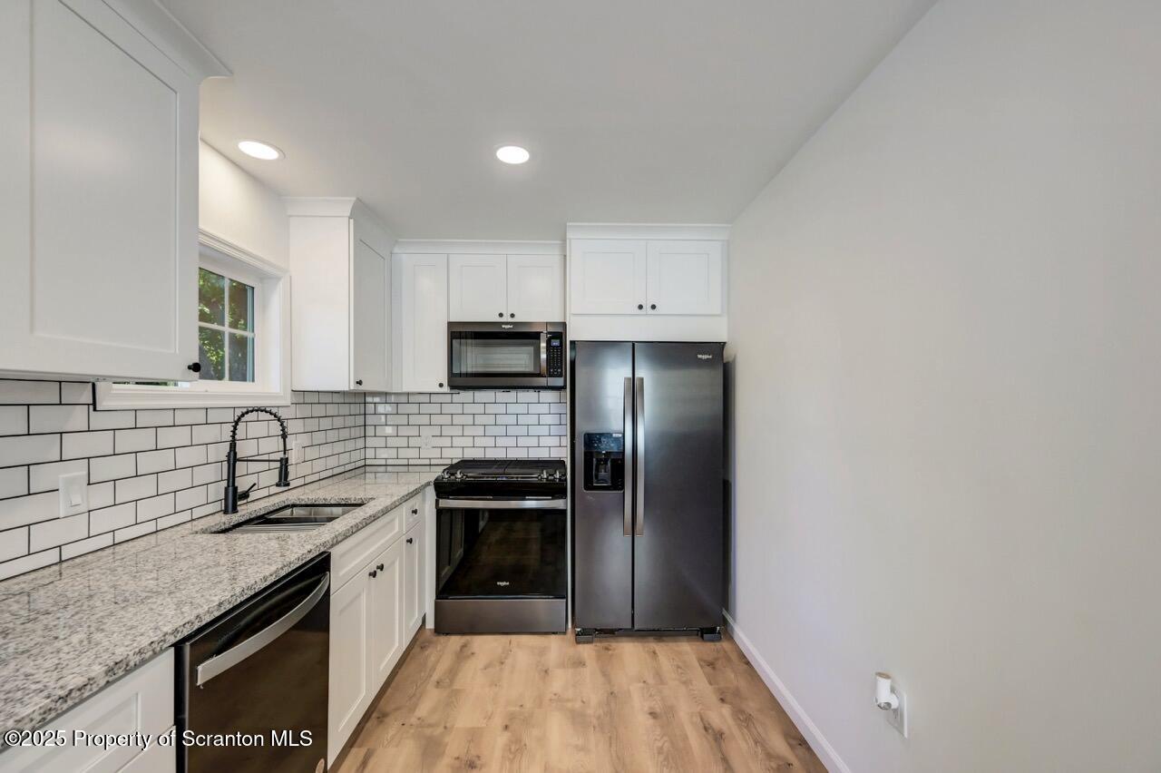 110 Morgan Street Jessup, PA 18434 - Photo 14 of 45 a kitchen with granite countertop a refrigerator stove and sink