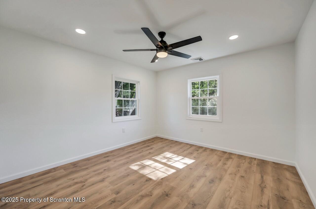 110 Morgan Street Jessup, PA 18434 - Photo 17 of 45 a view of empty room with wooden floor and fan