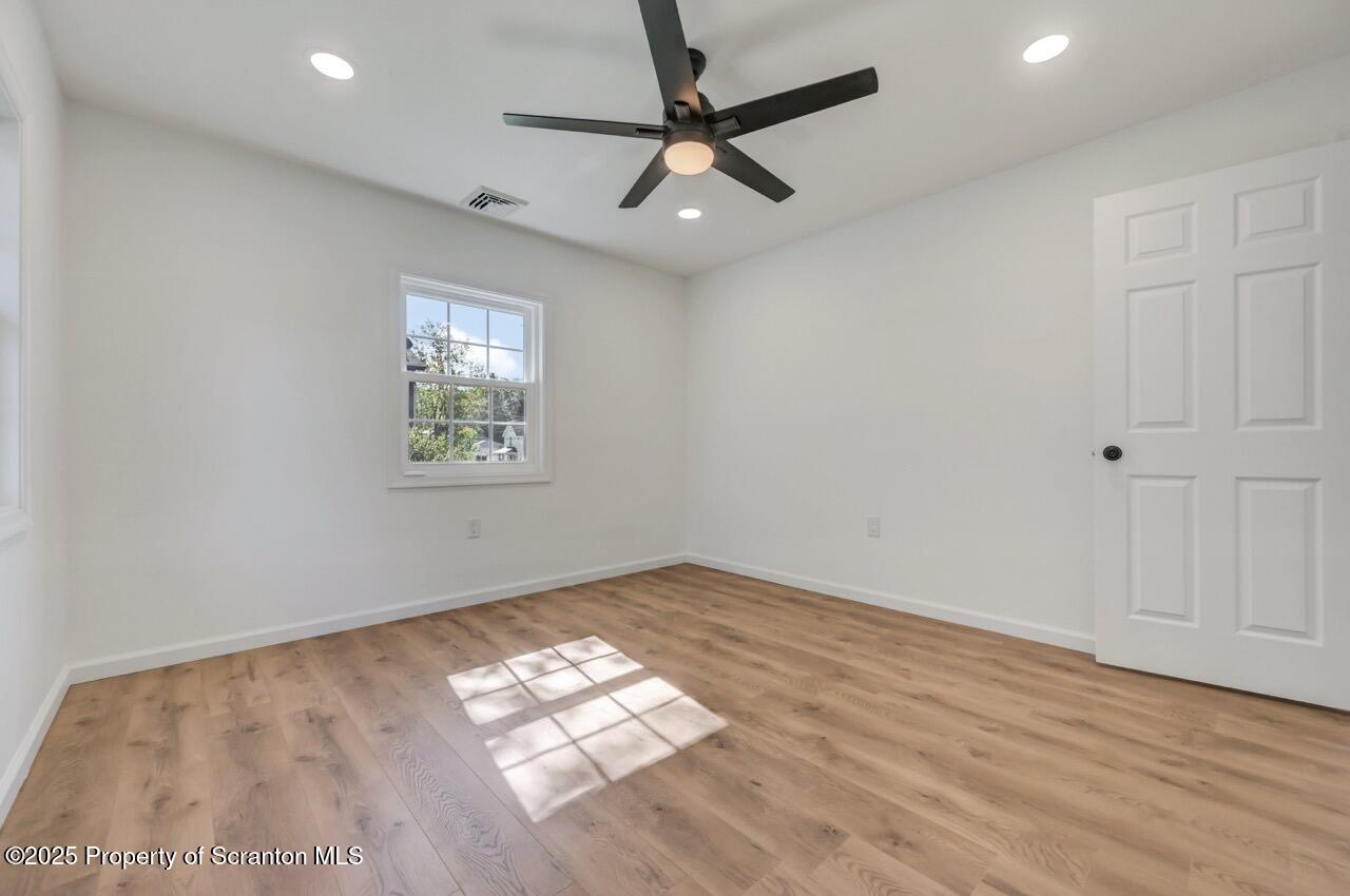 110 Morgan Street Jessup, PA 18434 - Photo 18 of 45 a view of empty room with wooden floor and fan