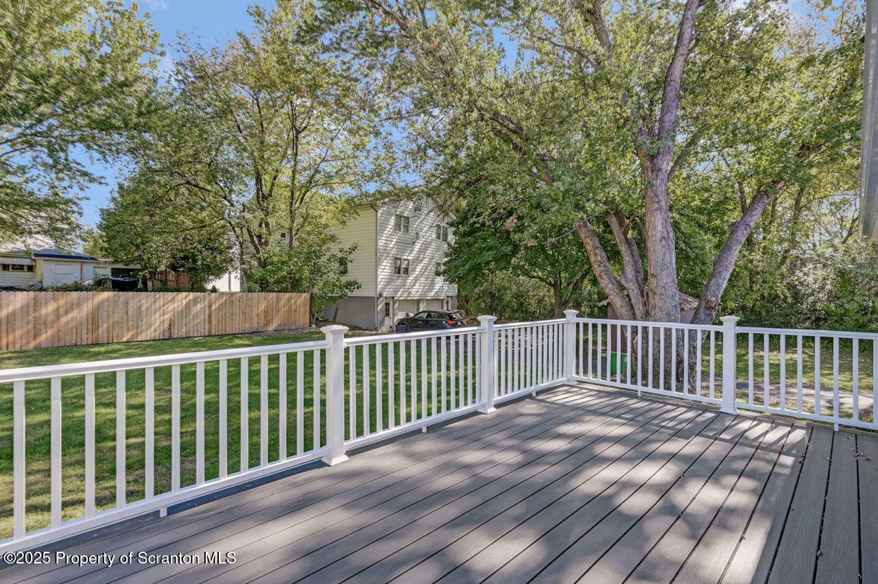 110 Morgan Street Jessup, PA 18434 - Photo 43 of 45 a balcony with wooden floor and fence