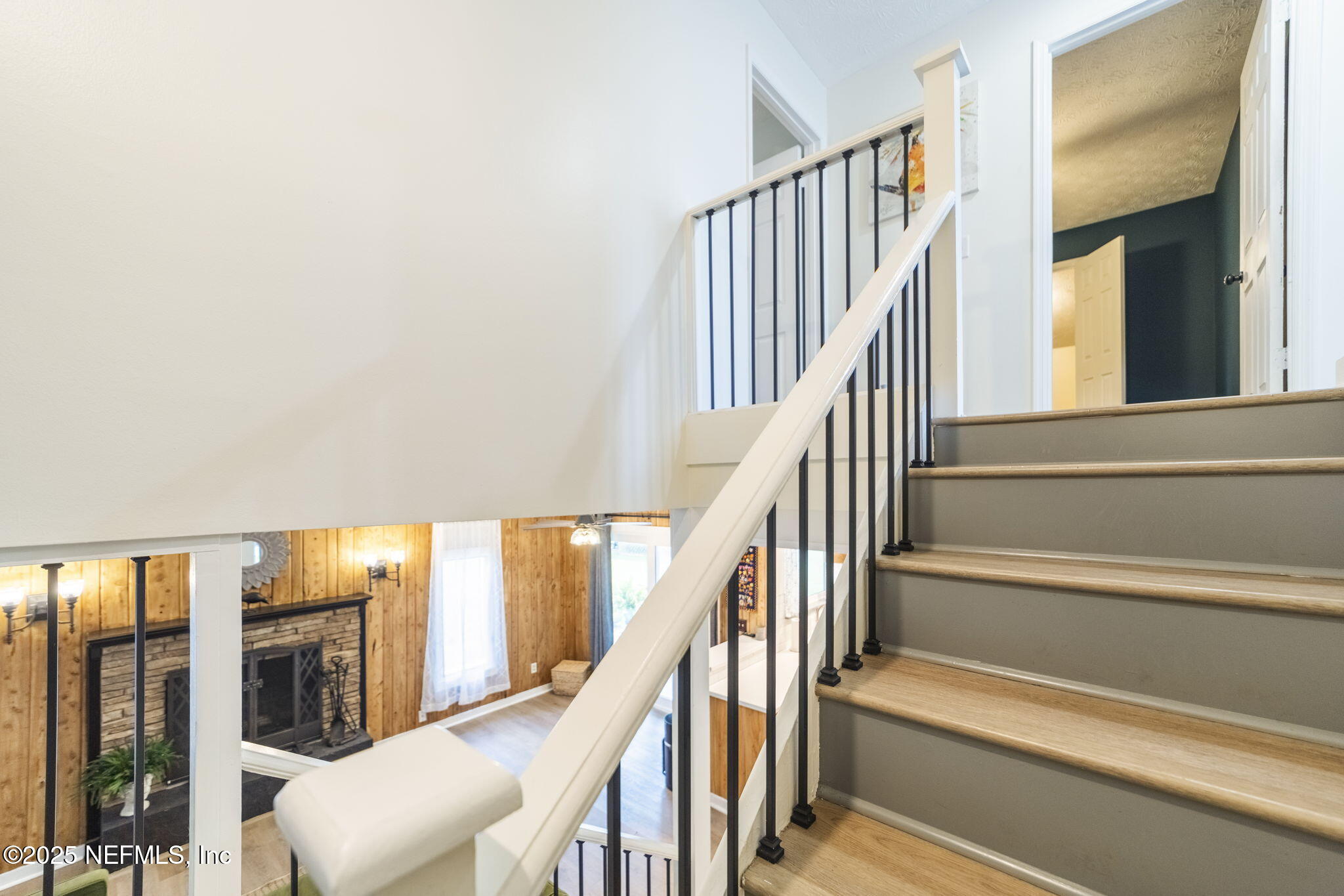 6183 George Hodges Road Macclenny, FL 32063 - Photo 45 of 97 a view of staircase with lots of frames on wall and wooden floor