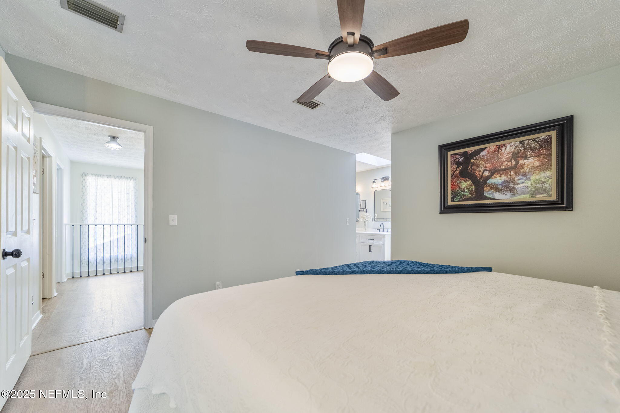 6183 George Hodges Road Macclenny, FL 32063 - Photo 50 of 97 a bedroom with a large bed and a chandelier