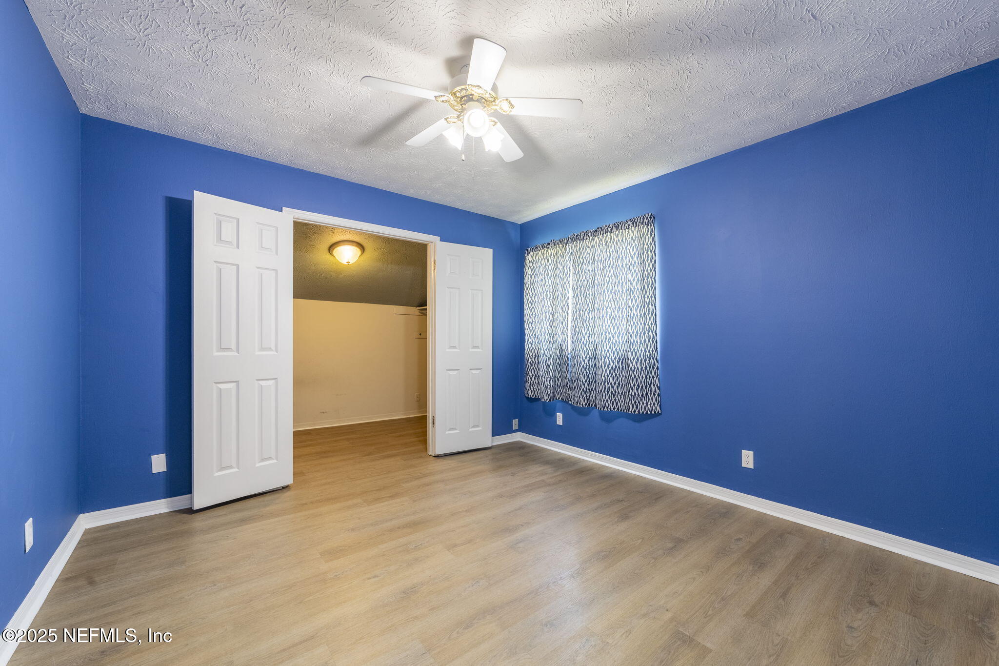 6183 George Hodges Road Macclenny, FL 32063 - Photo 67 of 97 a view of an empty room with window and chandelier fan