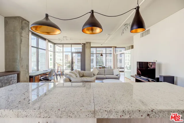 a living room with furniture a rug and a flat screen tv