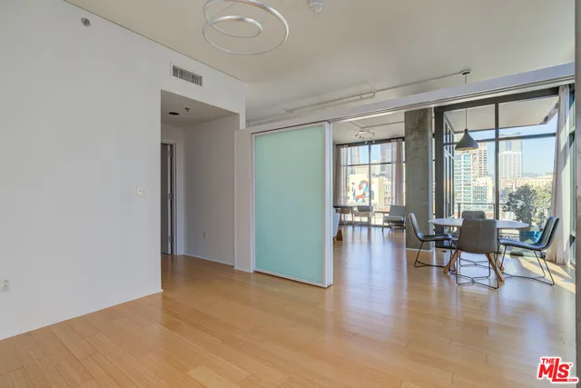 a view of a room with furniture and wooden floor