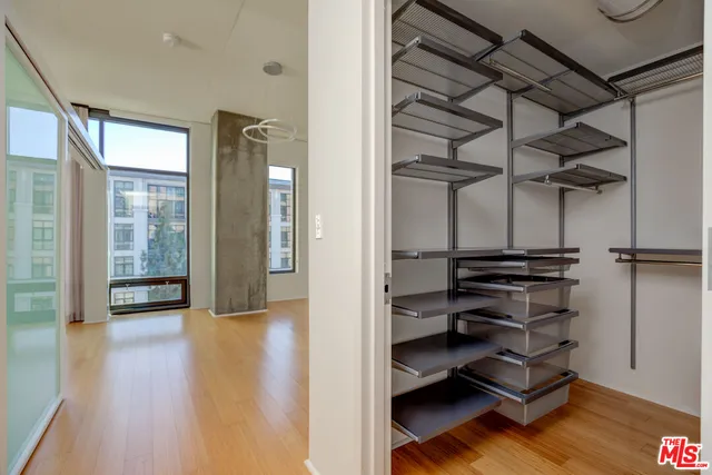 a room with wooden floor and windows